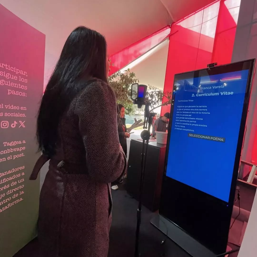 Mujer eligiendo poema en tótem interactivo durante activación